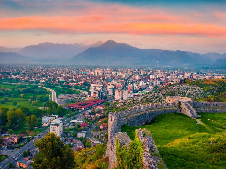 Spectacular evening view of Rozafa Castle. Incredible spring cityscape of Shkoder town. Attractive outdoor scene of Albania, Europe. Traveling concept background.