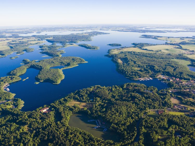 Aerial view of beautiful landscape of Mazury, Poland - islands on Kisajno Lake, Gizycko town on the right